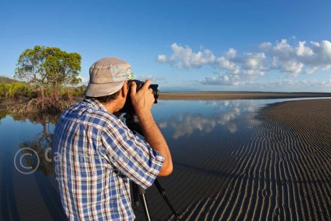 Image of photographer taking a photo on beach, Port Douglas, North Queensland, Australia