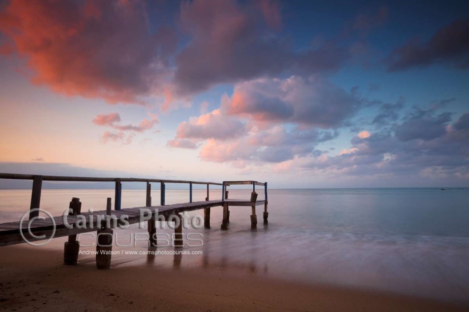 Image of wooden jetty extending into Coral Sea, Cairns, North Queensland, Australia